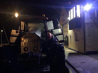 Sidmouth Lifeboat's tractor Mary Taylor sits in the dark outside the lifeboat station after responding to a shout